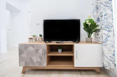 a tv on a tv stand in a living room at Apartamento Las Calas de Cadiz in Cádiz