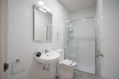 a bathroom with a toilet and a sink and a shower at Apartamento Las Calas de Cadiz in Cádiz