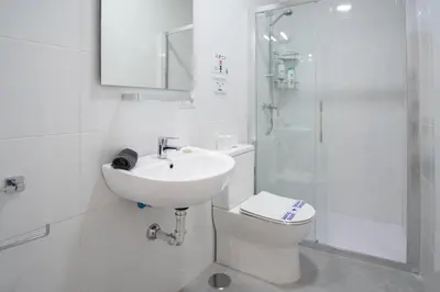 a bathroom with a sink and a toilet and a shower at Apartamento Las Calas de Cadiz in Cádiz