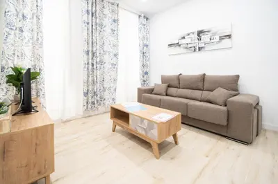 a living room with a couch and a coffee table at Apartamento Las Calas de Cadiz in Cádiz