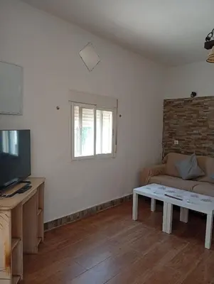 a living room with a couch and a table at Casa del abuelo trujillo 2 in Conil de la Frontera