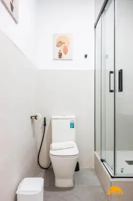 a bathroom with a toilet and a glass shower at Casa Rehala by Cadiz Time in Cádiz