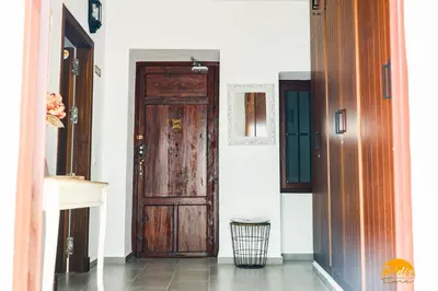 a hallway with a wooden door in a house at Casa Rehala by Cadiz Time in Cádiz