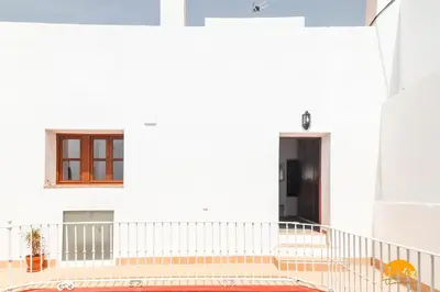a white building with a staircase and a window at Casa Rehala by Cadiz Time in Cádiz