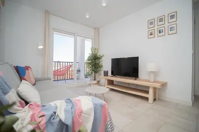 a living room with a couch and a television at SibsSanlucar Casa Manuela - Céntrico - Vistas Coto Doñana in Sanlúcar de Barrameda