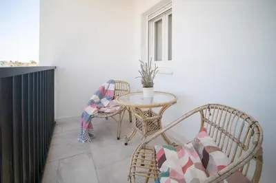 a small table and chairs in a room with a window at SibsSanlucar Casa Manuela - Céntrico - Vistas Coto Doñana in Sanlúcar de Barrameda