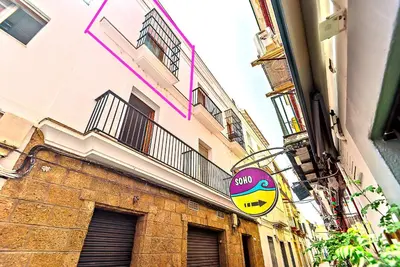 a building with a smiley face sign on the side of it at Plaza Herrería Central Apartments with Balconies in El Puerto de Santa María