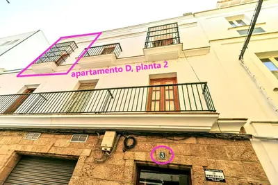 a building with a balcony on the side of it at Plaza Herrería Central Apartments with Balconies in El Puerto de Santa María