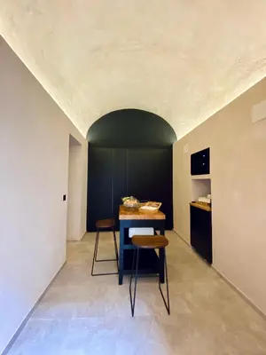 a room with a table and two stools at VICTORIA - by Ático73 in Medina Sidonia