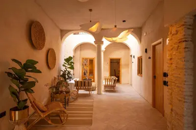 a hallway with arched ceilings and chairs in a house at VICTORIA - by Ático73 in Medina Sidonia