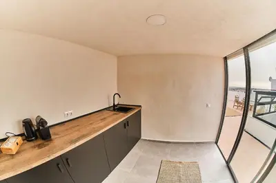a kitchen with a counter top and a large window at VICTORIA - by Ático73 in Medina Sidonia