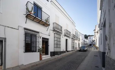 a car driving down a street next to buildings at VICTORIA - by Ático73 in Medina Sidonia