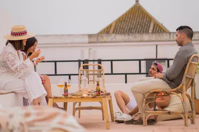 a group of people sitting on a roof at VICTORIA - by Ático73 in Medina Sidonia
