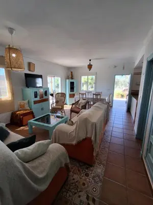 a living room with couches and a table in a room at Villa Jaca azule in Chiclana de la Frontera