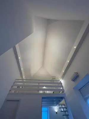 a staircase in a room with a ceiling at Loft EL DUQUE in Sanlúcar de Barrameda