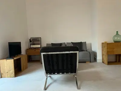 a living room with a couch and a television at Loft EL DUQUE in Sanlúcar de Barrameda