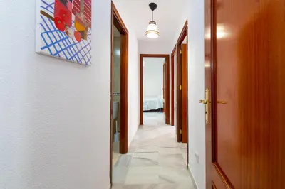 a corridor of a room with a hallway at Casa Melqart in Chiclana de la Frontera