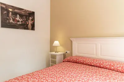 a bedroom with a bed and a picture on the wall at Casa Melqart in Chiclana de la Frontera