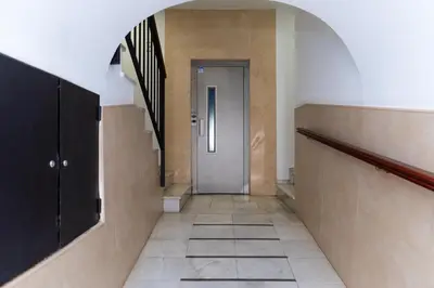 a hallway with a door and stairs in a building at Casa Melqart in Chiclana de la Frontera
