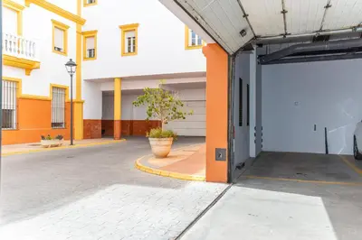 an empty parking lot in a building with an open door at Casa Melqart in Chiclana de la Frontera