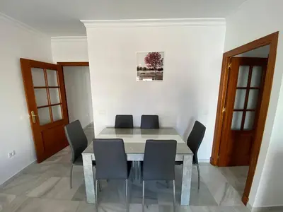 a dining room with a table and chairs at LAS INFANTAS HOME in Sanlúcar de Barrameda