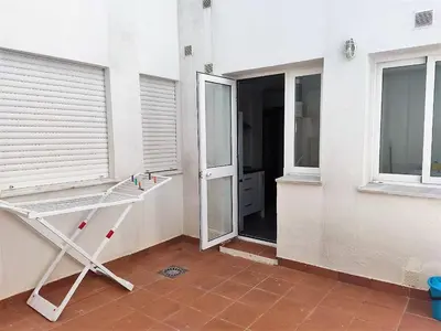 an empty room with a window and a door at LAS INFANTAS HOME in Sanlúcar de Barrameda