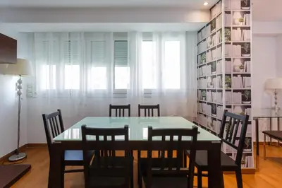 a dining room with a table and chairs at El Velero en la playa Victoria Grupo AC Gestion in Cádiz