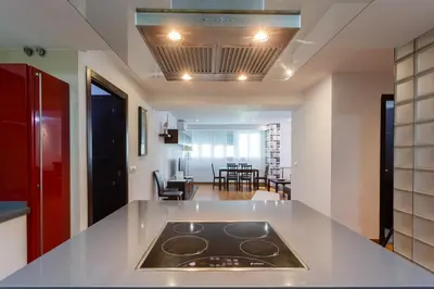 a kitchen with a stove top on a counter top at El Velero en la playa Victoria Grupo AC Gestion in Cádiz