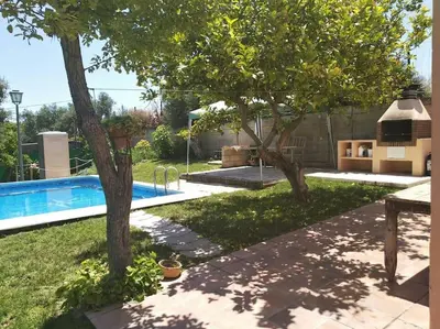 a backyard with a swimming pool and two trees at Vivienda Rural La choza in Jerez de la Frontera