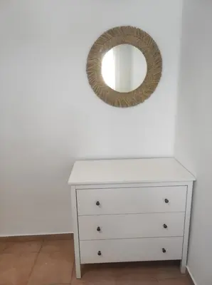 a white dresser with a mirror on a wall at Apartamento Bajamar in El Puerto de Santa María