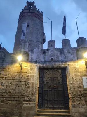 a castle with a wooden door in front of it at Apartamento Bajamar in El Puerto de Santa María