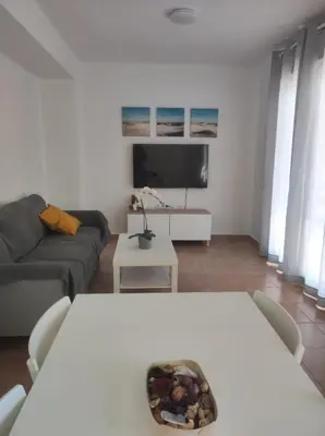a living room with a couch and a table at Apartamento Bajamar in El Puerto de Santa María