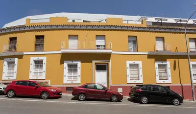 three cars parked in front of a yellow building at Azvalia - Atarazana in El Puerto de Santa María