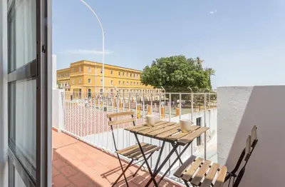 a balcony with a table and chairs on a building at Azvalia - Atarazana in El Puerto de Santa María