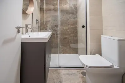 a bathroom with a toilet and a sink and a shower at Apartamento Sunset Cádiz in Cádiz