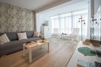 a living room with a couch and a table at Apartamento Sunset Cádiz in Cádiz