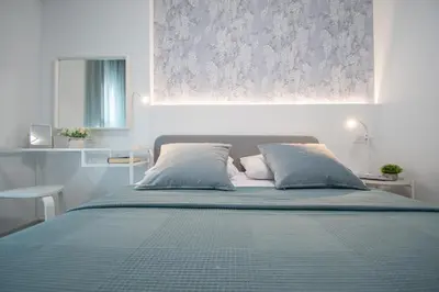 a bedroom with a bed with a blue comforter at Apartamento Sunset Cádiz in Cádiz