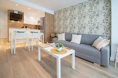 a living room with a couch and a table at Apartamento Sunset Cádiz in Cádiz