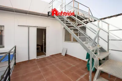 a ladder in an empty room with a staircase at El Anfitrión - La Cómoda in Sanlúcar de Barrameda