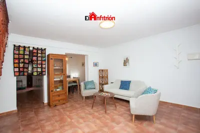 a living room with a couch and chairs and a table at El Anfitrión - La Cómoda in Sanlúcar de Barrameda