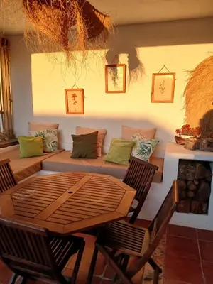 a living room with a couch and a table and chairs at La Estrella - piscina privada in Chiclana de la Frontera