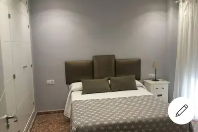 a bedroom with a large bed in a room at Disfrutar de Sanlucar de Barrameda in Sanlúcar de Barrameda