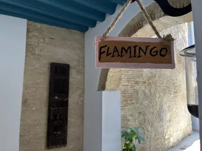 a sign that reads flamingo hanging in front of a building at CAMASanlúcar in Sanlúcar de Barrameda