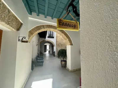 a hallway in a building with a sign that reads calcilia at CAMASanlúcar in Sanlúcar de Barrameda