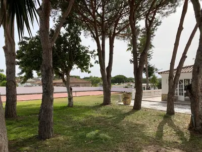 a group of trees in front of a building at La Ranaverde, piscina y playa in Chiclana de la Frontera
