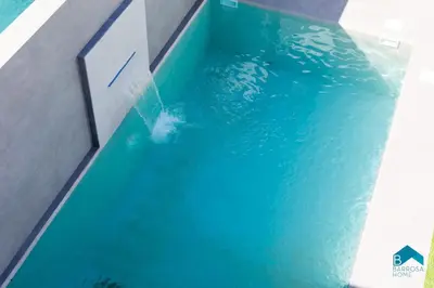 a pool of blue water with a fountain at Sauz B in Chiclana de la Frontera