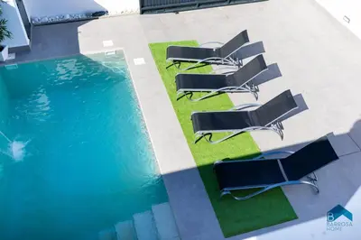 an overhead view of a pool with chairs next to it at Sauz B in Chiclana de la Frontera