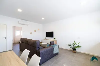 a living room with a couch and a tv at Sauz B in Chiclana de la Frontera