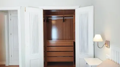 a closet in a bedroom with white walls at Sherryflat Laurel in Jerez de la Frontera