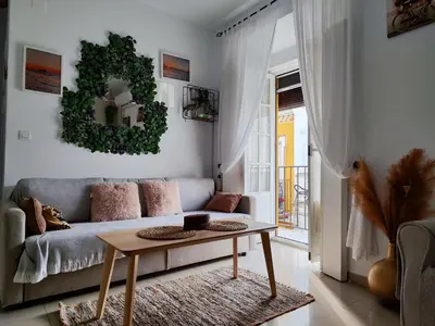 a living room with a couch and a table at Apartamento Cristina centro in Sanlúcar de Barrameda